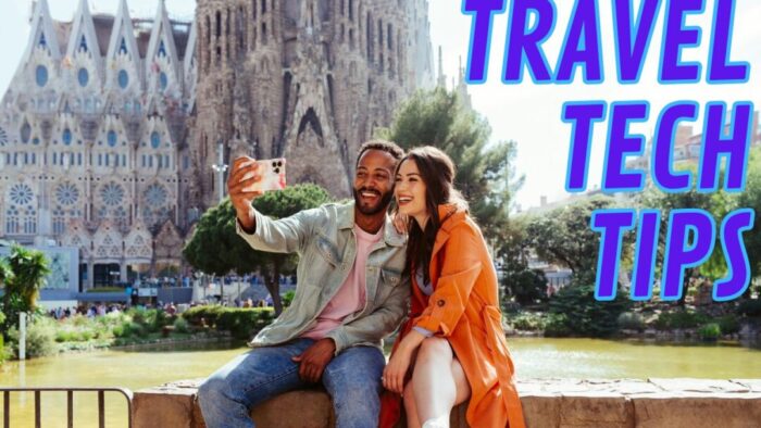 couple sitting on a stone wall in front of a pond that's in front of a gothic-style building, presumably a church. blue text on the photo reads "travel tech tips"
