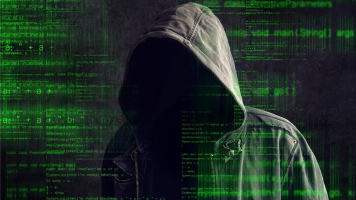 a Matrix-style green digital background with a person in a hooded jacket. No face is visible from the jacket hood.