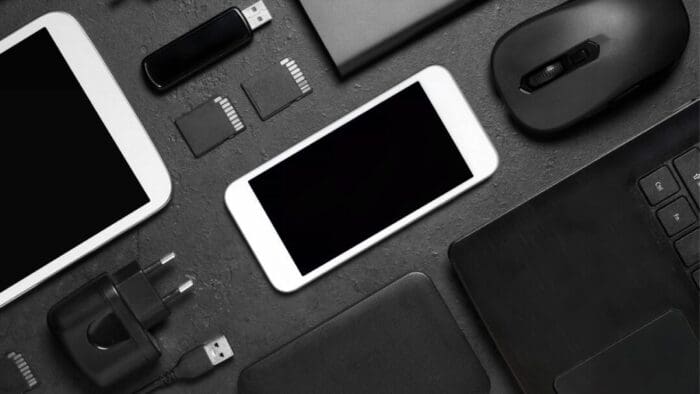 black background with a diagonal assortment of devices, both Apple and non-Apple.