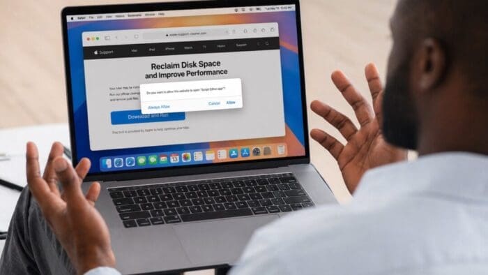 man with an open laptop on his lap in a WTF pose. on screen there is a pop up asking to install a script.