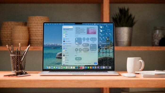 an open Mac laptop sitting on a desk with a coffee cup to the right and a pencil cup to the left. there is a bookcase in the background. on the screen is Control Center and the settings for it.